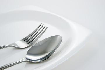 Fork and Spoon on white dish