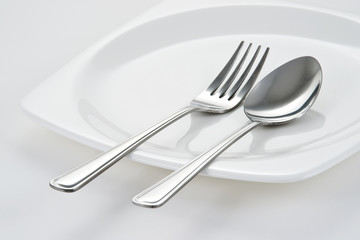 Fork and Spoon on white dish