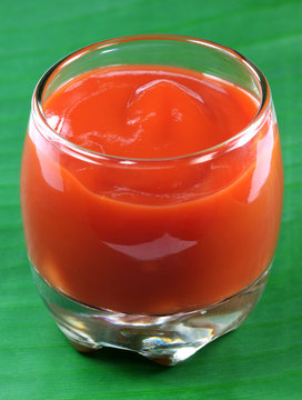 Tomato Ketchup On A Glass Pot Over Green Banana Leaf