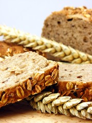 Brown bread & wheat on a wooden board