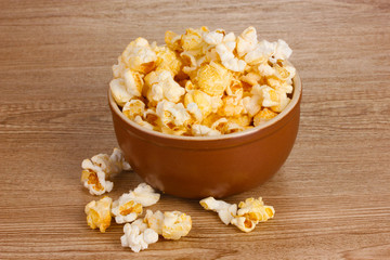 popcorn in brown bowl on wooden table
