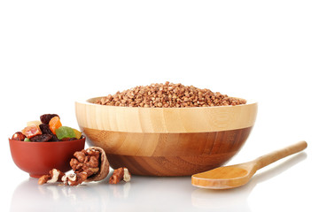 Raw buckwheat with dried fruits isolated on white
