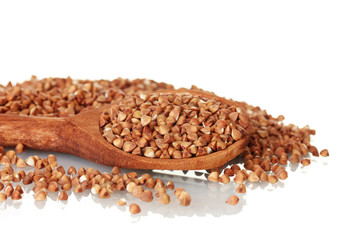 Wooden spoon with raw buckwheat isolated on white