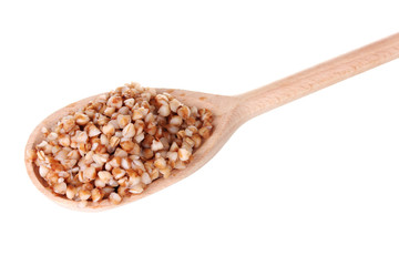 Wooden spoon with boiled buckwheat isolated on white