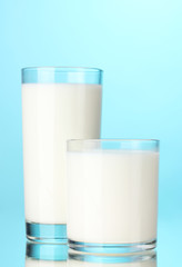 Two glass of milk on blue
