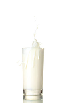 Glass of milk with a splash isolated on white