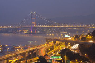 Tsing Ma Bridge and highway at sunset, show the modern landscape