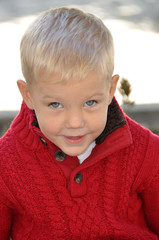 Cute Little Boy Sitting on Bench