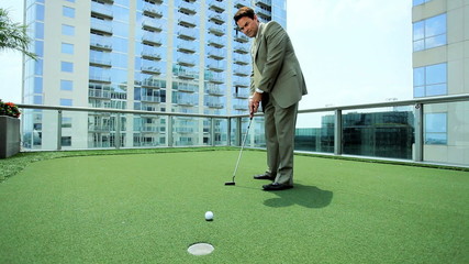 Young Executive Practicing Golf on Office Rooftop - Powered by Adobe