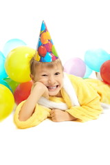 smiling little boy in dressing gown celebrates his birthday