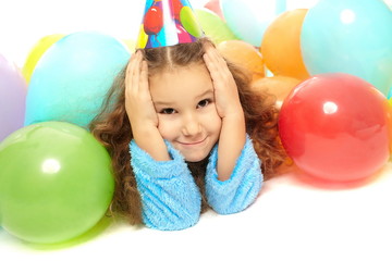 Fototapeta na wymiar smiling little girl in dressing gown celebrates her birthday