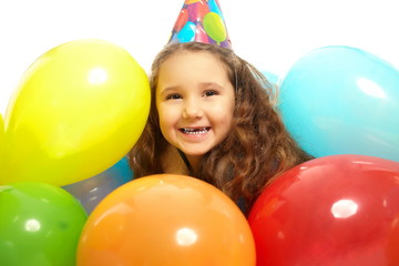 Fototapeta na wymiar smiling little girl in dressing gown celebrates her birthday