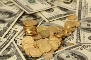 gold coins on the dollar backgrond
