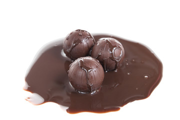 chocolate balls with liquid chocolate isolated on white