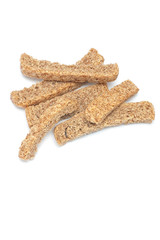 Closeup of a bunch of whole-wheat grain rusks on white