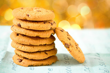 chocolate chip cookies on blue table set with bokeh background