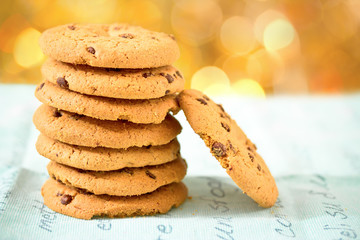 chocolate chip cookies on blue table set with bokeh background