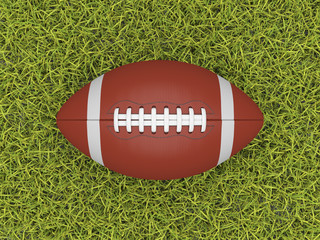 American football ball isolated on a grassy background