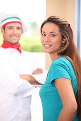 Pizza chef stood at customers door