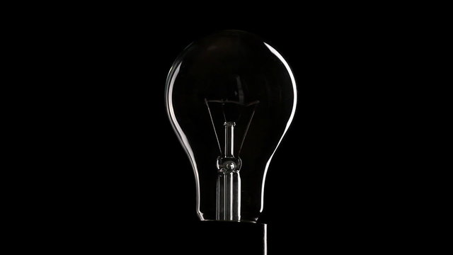 Light bulb over black background