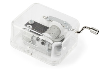 little clockwork toy transparent musical box on white