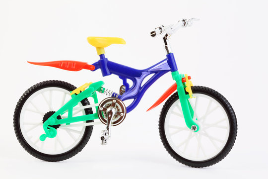 colorful plastic toy two-wheeled bicycle on white
