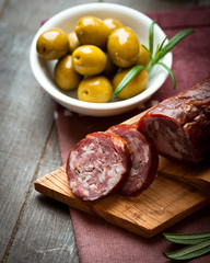 Cured dry sausage on chopping board