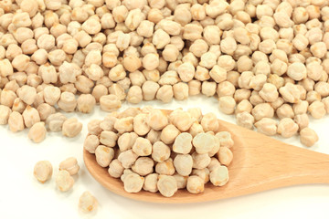 Chick Peas seeds on pile and in wooden spoon.