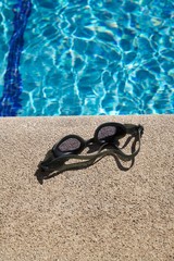 goggles on curb of swimming pool