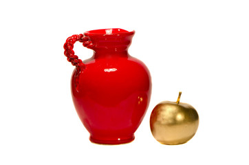 red jug and golden painted apple