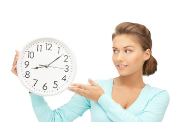 woman holding big clock