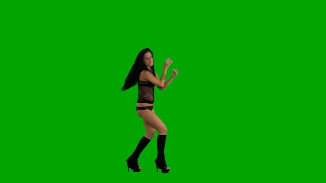 Beautiful young girl dancing against green screen