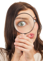 Woman looking through a magnifying glass