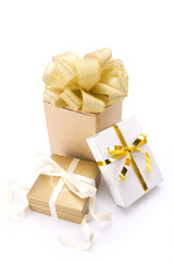 three gold gift boxes with gold classic ribbon.