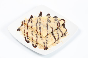 Chocolate pancakes served on white plate