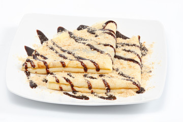Chocolate crepes (pancakes) served on white plate