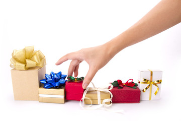 hand choosing red gift box amoung many boxes.