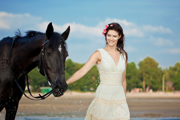 Woman on a horse by the sea