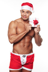Image of sexy male wearing xmas costume and holding a gift