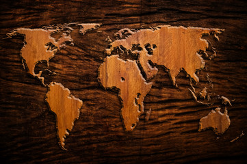 wood background with world map carving