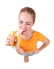 Young funny woman eat banana