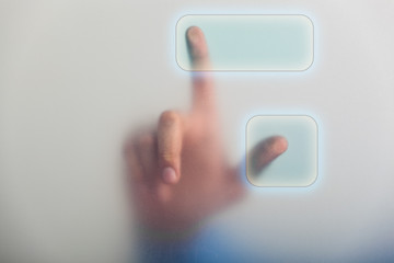 A pointing finger pressing a touch screen button