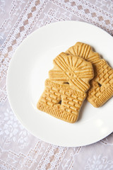 Dutch windmill cookie on dinner plate on table