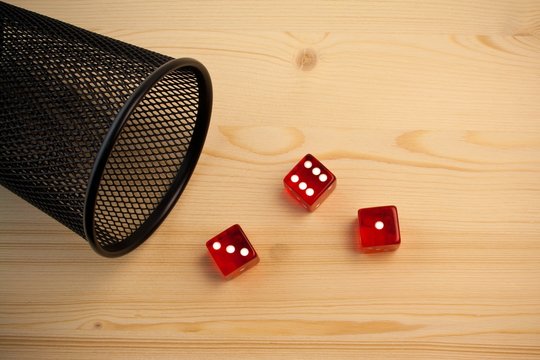 red dice near a container