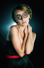 Pretty young girl with painted mask on her face