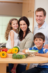 Young family standing in the kitchen