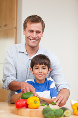 Fototapeta na wymiar Father and son preparing vegetables