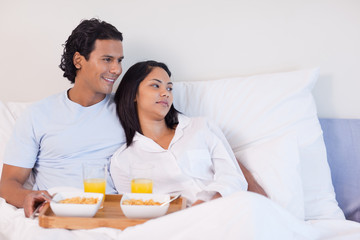 Obraz na płótnie Canvas Couple having breakfast in the bed