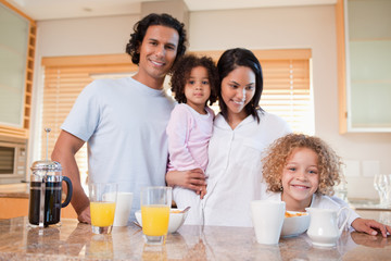 Obraz na płótnie Canvas Happy family having breakfast in the kitchen together