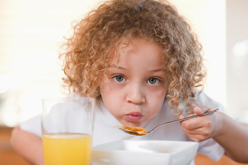 Girl having breakfast in the kitchen